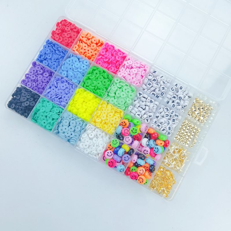 The Fashiongirl Clay Beads / Heishi Beads Fimo Kit is a 4500-piece jewelry kit with 24-compartment plastic organizer, filled with vibrant flat round beads, letter beads, smiley faces, and gold metallic beads—sorted by type and color.