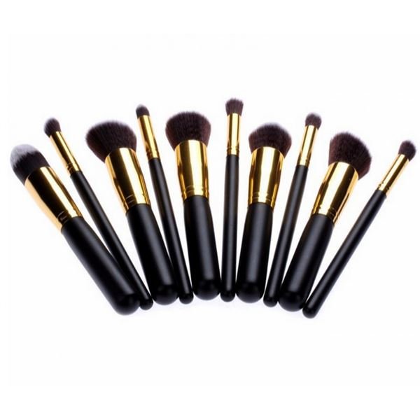 The PRO Makeup Brush Set Black/Gold includes 10 premium kabuki and precision brushes with black handles and gold ferrules, offering various sizes and shapes for flawless application. Brushes are arranged in a row on a white background.
