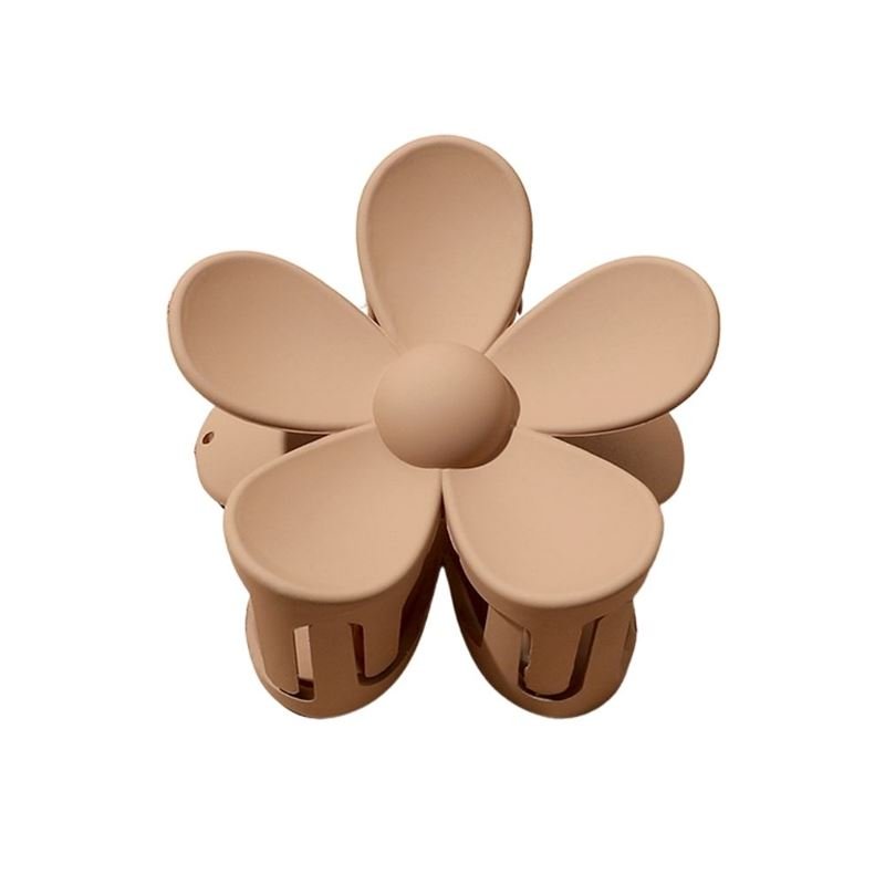 The SOHO Bloom Hair Claw - Brown by SOHO features a charming six-petal flower design with smooth, rounded petals and a circular center—making it the perfect stylish accessory for any look.