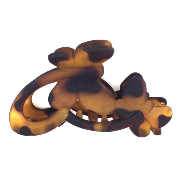 The SOHO Hair Claw - Butterflies by SOHO is a smooth, matte-finish hair accessory featuring a playful butterfly design, adding a unique and stylish touch to any hairstyle.