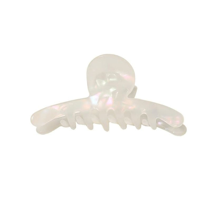 The SOHO Haylen Hair Claw in white features a pearly marble finish, rounded top, and wide curved teeth—displayed against a plain white background. This SOHO accessory adds everyday chic to your hairstyle.