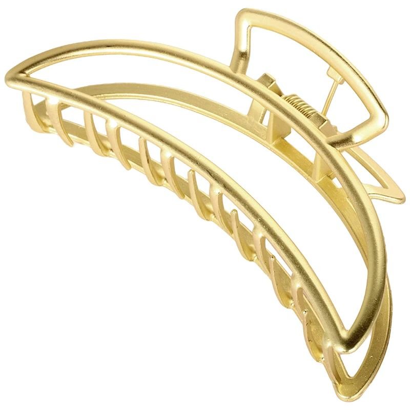 The SOHO Lyra Large Metal Hair Claw in gold features a curved, open-frame design with interlocking teeth—ideal for securing a messy bun or styling elegant hairdos.