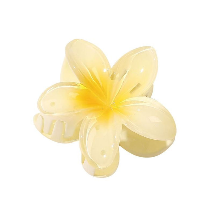 The SOHO Moana Hair Claw - Yellow is a light yellow, flower-shaped hair accessory by SOHO with five glossy petals and a spring clasp, inspired by the plumeria flower—ideal as a summer accessory.