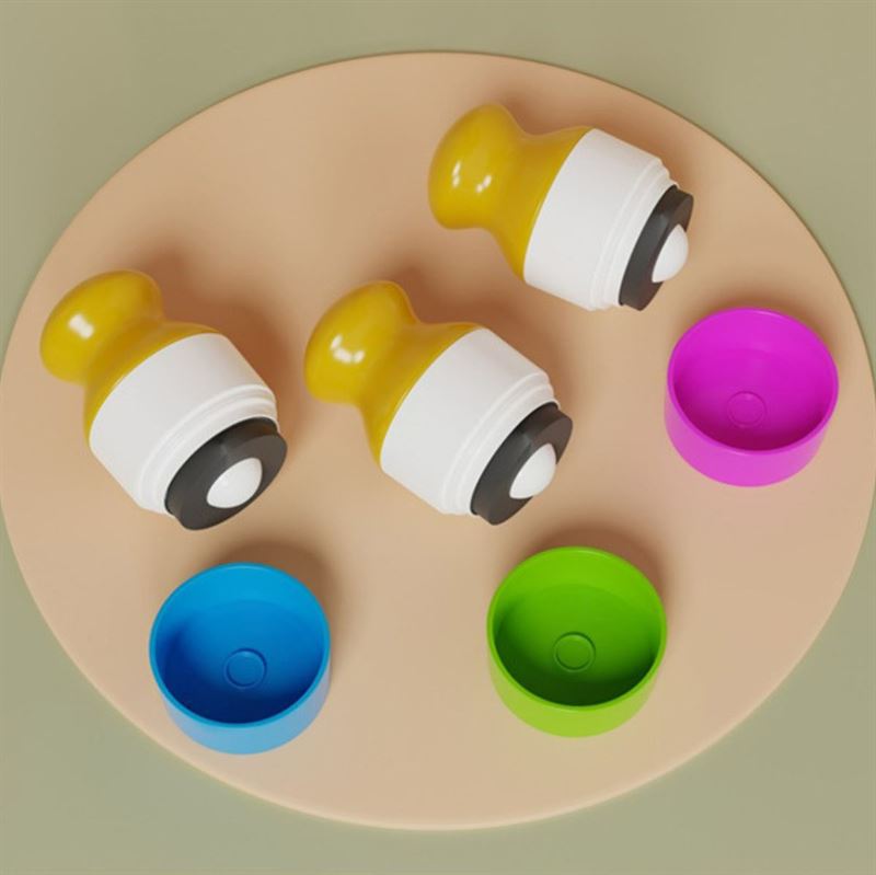 Three UNIQ Portable Refillable Sponge Roller Applicators (100ml) by UNIQ, in yellow and white with black bases, are lined up on a beige surface. Each is paired with a colorful cap (pink, blue, green) for mess-free sunscreen or lotion application for kids.