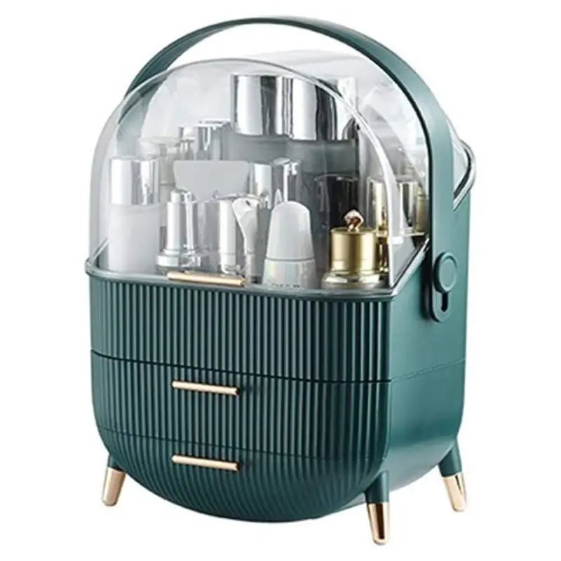 The UNIQ Retro Makeup Box Organiser in Dark Mint/Dark Green features a clear domed lid, two gold-handled drawers, gold-tipped legs, and a spacious top compartment to neatly store your beauty essentials.